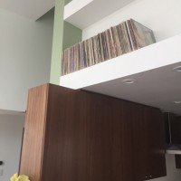 kitchen cabinetry with built-in shelving above