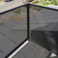 detail of perforated metal exterior rail
